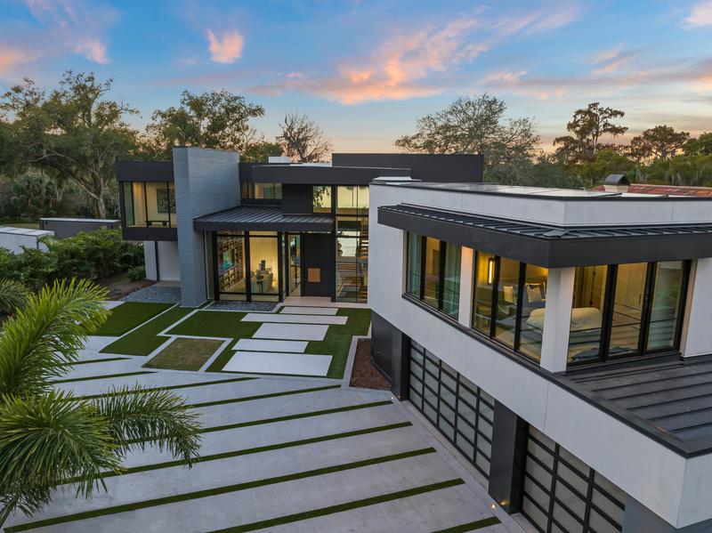 Rear exterior and pool terraces at dusk — The New American Home 2026, Orlando FL