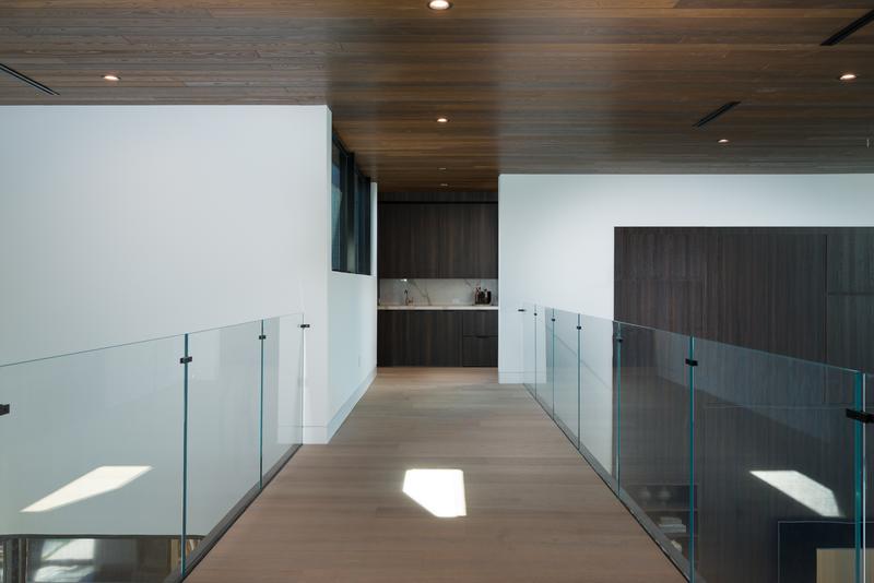 Glass-railed bridge hallway — The New American Home 2026, Orlando FL