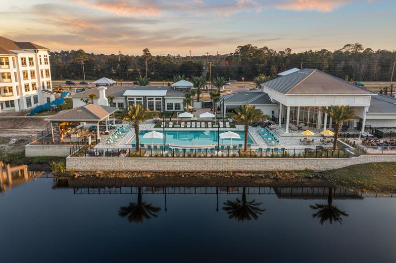 Aerial view across the lake at sunset — Sanctuary at Daytona apartments, Daytona Beach FL